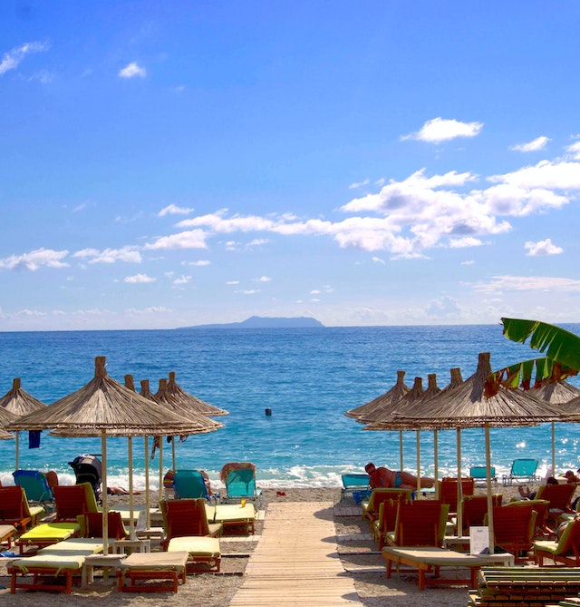 beautiful beach with deckchairs and beach umbrellas