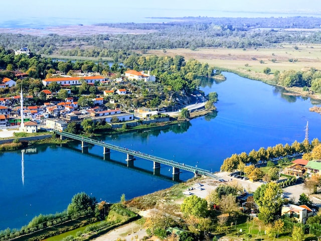 a bridge on the river with green nature on both sides